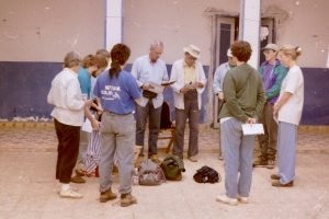 Photo of Each morning our team gathers in a circle for meditation and sharing. Fred Arnold (in light blue shirt, shared: “Before this trip my soul felt parched and dry. As we wait for the truck to take us to the worksite, I feel my soul is full as we share this work with these people.” (1998)