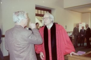 (Photo of minister in a red robe) Rev, Dr. William Sloane Coffin, Jr., responding to a question after his talk in the Madison Church, “Homosexuality, the Last Prejudice.”